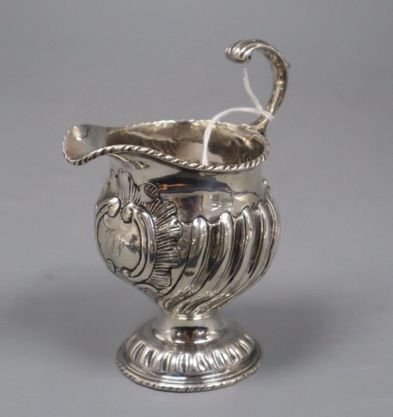 An early George III silver cream jug, London, 1764, with later embossed decoration, 12cm, 4 oz.